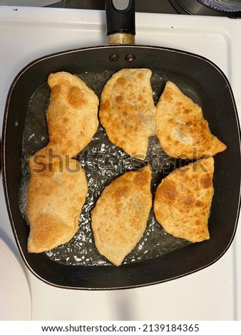 Chebureki is krym-tatar national food. It is fried pie from dough with salted meat and onion with black pepper. Sometimes it’s snack, like street food. It is popular  in countries of the former USSR.  Zdjęcia stock © 