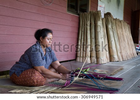 The native women is working on traditional hand made mat in Talaynoi, Phatthalung province, Thailand. May 16, 2015