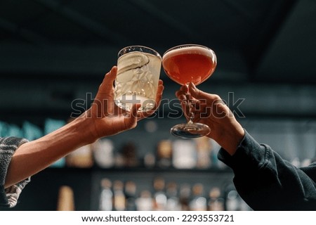 Image, Stock Photo Two people cheering with pink cocktails outside on a terrace on a sunny day with swimming pool in the background