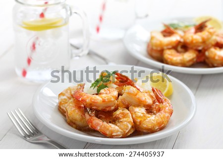 garlic shrimp, hawaiian food on white wooden background