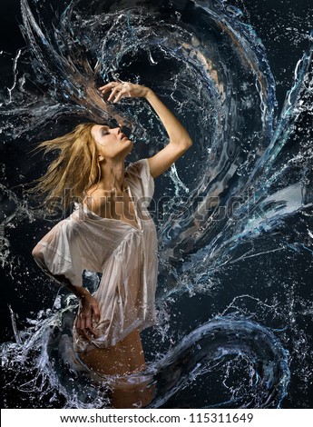 Aqua girl with wet shirt in a spray of water a liquid dragon before her