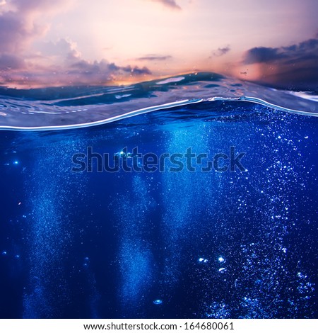 Tropical postcard sea water design template. Beautiful sunset at the sea nice pink clouds and blue water with air bubbles