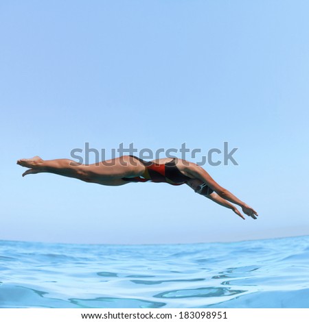 Side view of a girl diving in the swimming pool