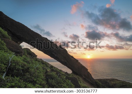 Long exposure of sunrise from the top of a popular hike on the east side of Oahu, Hawaii. The daytime long exposure creates a smooth surface over the ocean and a motion blur in the clouds.