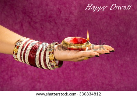 woman hands holding lantern (oil lamp) during diwali festival of lights