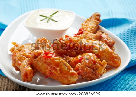 fried chicken wings with sweet chili sauce on white plate