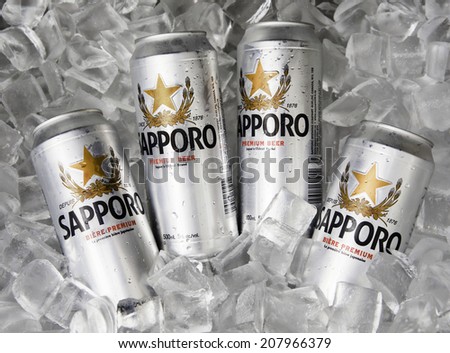Toronto, Canada - September 11, 2012: Four silver cans of Sapporo beer being chilled on a bed of ice.