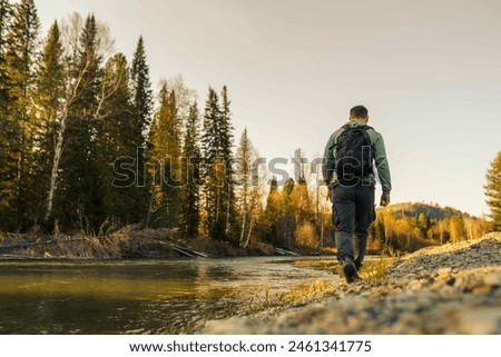 Similar – Foto Bild Person, die auf einer Landstraße zwischen Meer und Feld geht