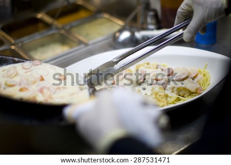 creamy seafood Fettuccine alfredo pasta dish with shrimp and fried fish
