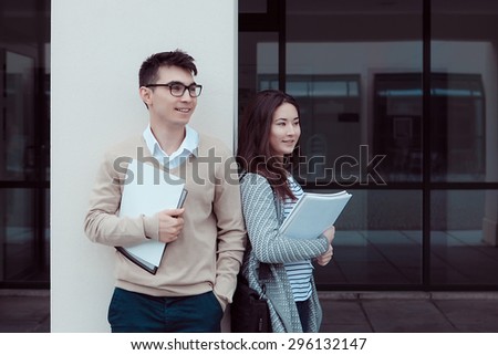 smart students man and woman student standing Outside Building of college