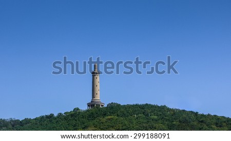 DALIAN, CHINA - 2014: White Jade Hill Tower at Baiyu Mountain. Construction finished in 1909 for Imperial Japanese Army showing loyalty to emperor of Japan, located in Lushunkou, Dalian.