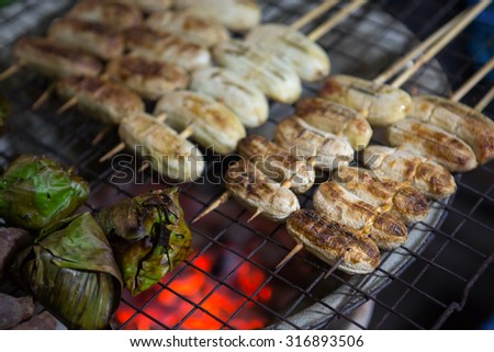 Thai dessert Grilled bananas from natural wood charcoal Snacks in Thailand Grilled sweet banana in local market