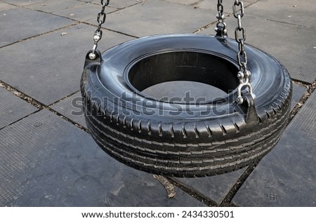 Similar – Image, Stock Photo black chain Tire Swing at a children’s  play ground no people