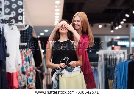 A girl is found a beautiful thing in the store and decided to make a surprise for her friend. Her friend is waiting and smile.