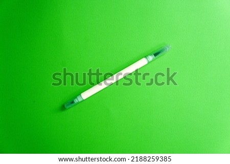 Emerald green marker on a green background, a fresh mood. Back to school. Double sided art marker. Color mood