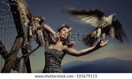 Fashionable photo of a woman holding eagle