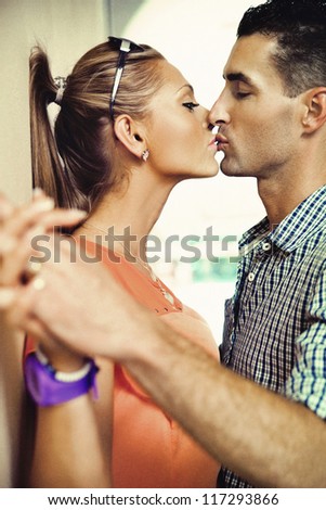 Two young people kissing