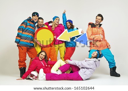 Smiling group of friends wearing snowboard costumes