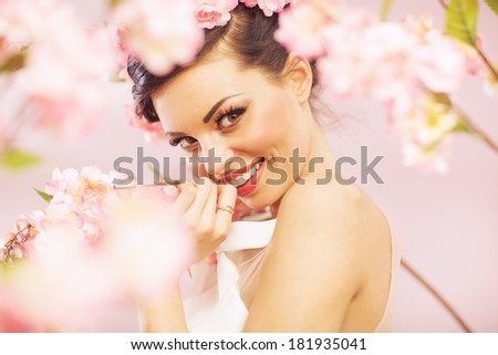 Beautiful smiling woman with spring flowers