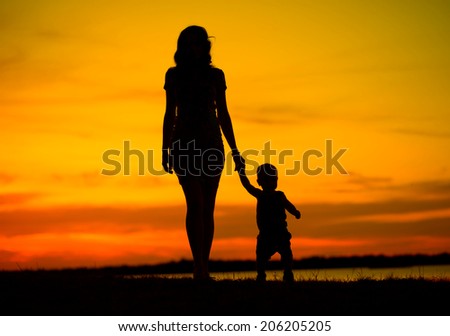 Silhouette of a young mother with her little child