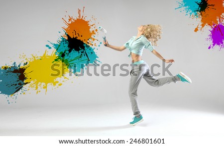 Young joyful woman with a paint roll