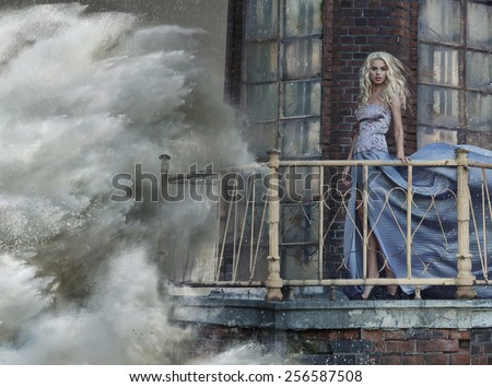 Young blonde woman on the sea storm