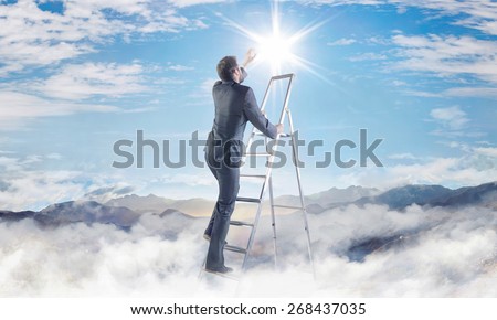 Businessman climbing on ladder in the clouds