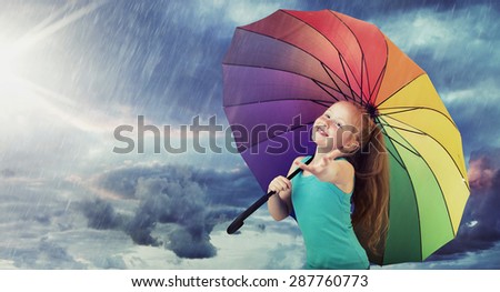 Happy child with a colorful umbrella