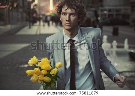 Attractive guy with bunch of tulips