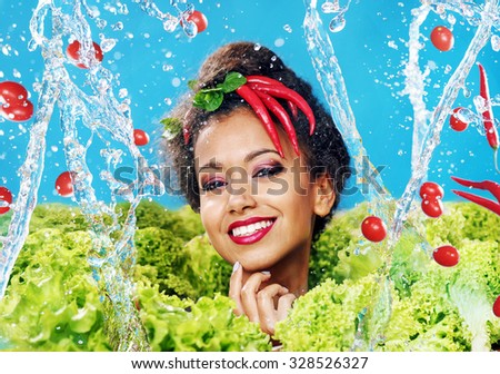 Beautiful woman with healthy food and water splashes