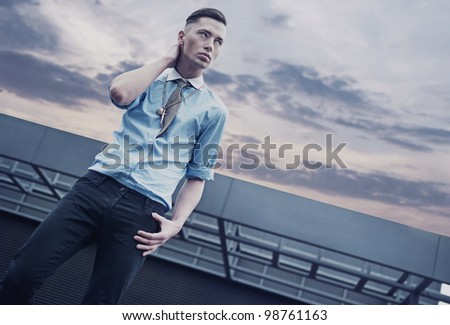 Handsome guy on a roof of a building