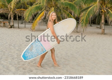 Similar – Image, Stock Photo Content female surfer walking on beach with surfboard