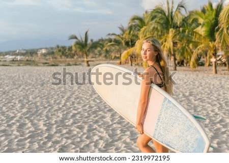 Similar – Image, Stock Photo Content female surfer walking on beach with surfboard