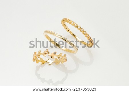 Pairs of jeweled jewelry rings lined up next to each other on a white background 商業照片 © 