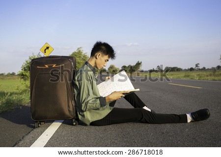 Man sitting on a road trip map.