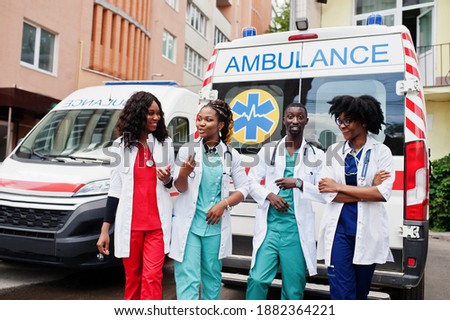 Similar – Image, Stock Photo Group of doctors transporting patient to operating room