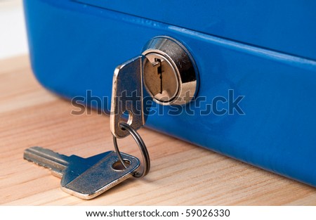 blue cash money box and two key. closeup.