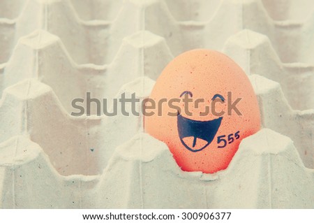 augh face Eggs  in empty carton