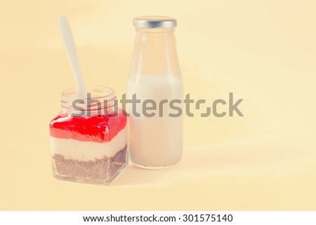 Strawberry Brownie cake  in a glass jar with milk.