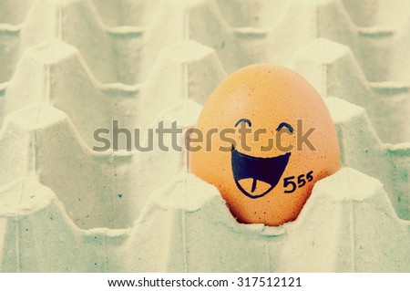 augh face Eggs  in empty carton