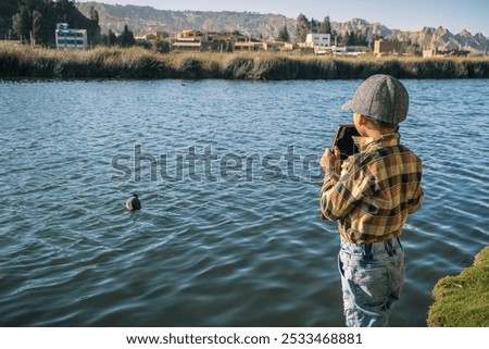 Similar – Image, Stock Photo brother taking a picture of his sister with mobile phone