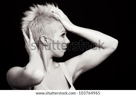 portrait of a beautiful caucasian woman with hand in hair - isolated on black background