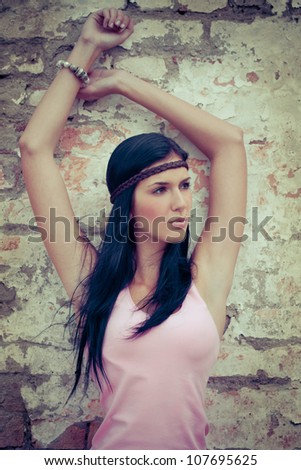 fashion woman in front of a grunge brick wall - colorized photo
