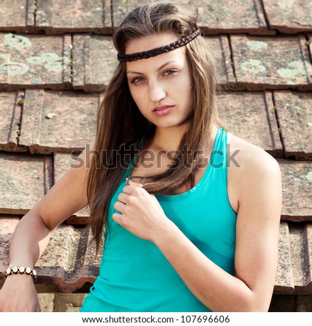 fashion woman in front of a grunge tiles