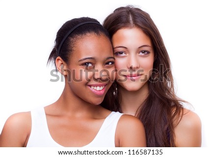 portrait of young different nationalities teenage girlfriends, caucasian woman and african american woman - isolated on white background