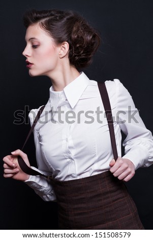 young fashion woman wearing old style formal clothes, white shirt and skirt, suspenders