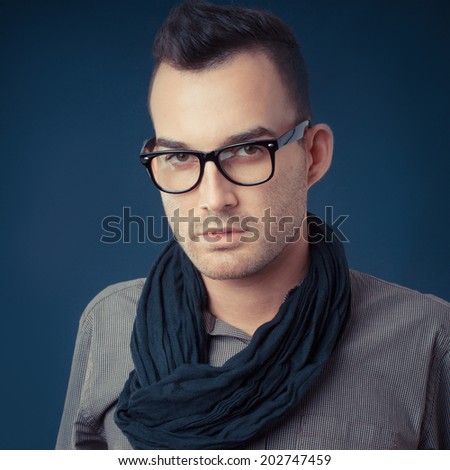 handsome young fashion man wearing scarf - shot in studio