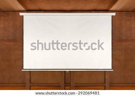 empty projector screen on wooden wall