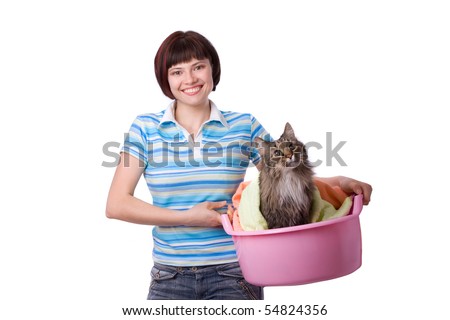 Housewife with laundry basket with dirty cat.  A young woman holding a basket of folded laundry. Time for laundry day.