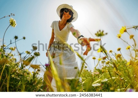 Similar – Image, Stock Photo Cute girl touching flowers in a french lavender field at sunset
